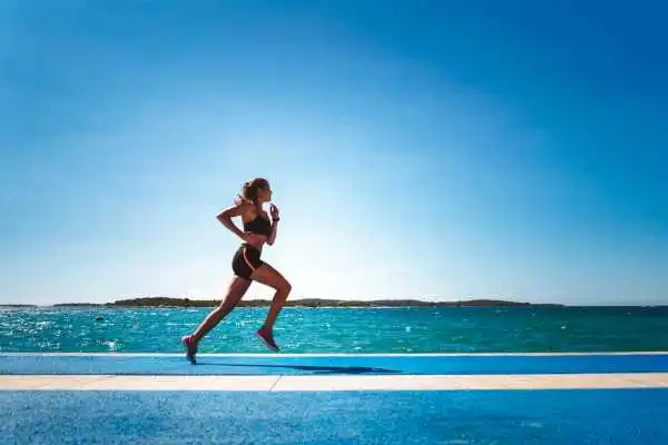Woman running showing strong leg muscle Slough
